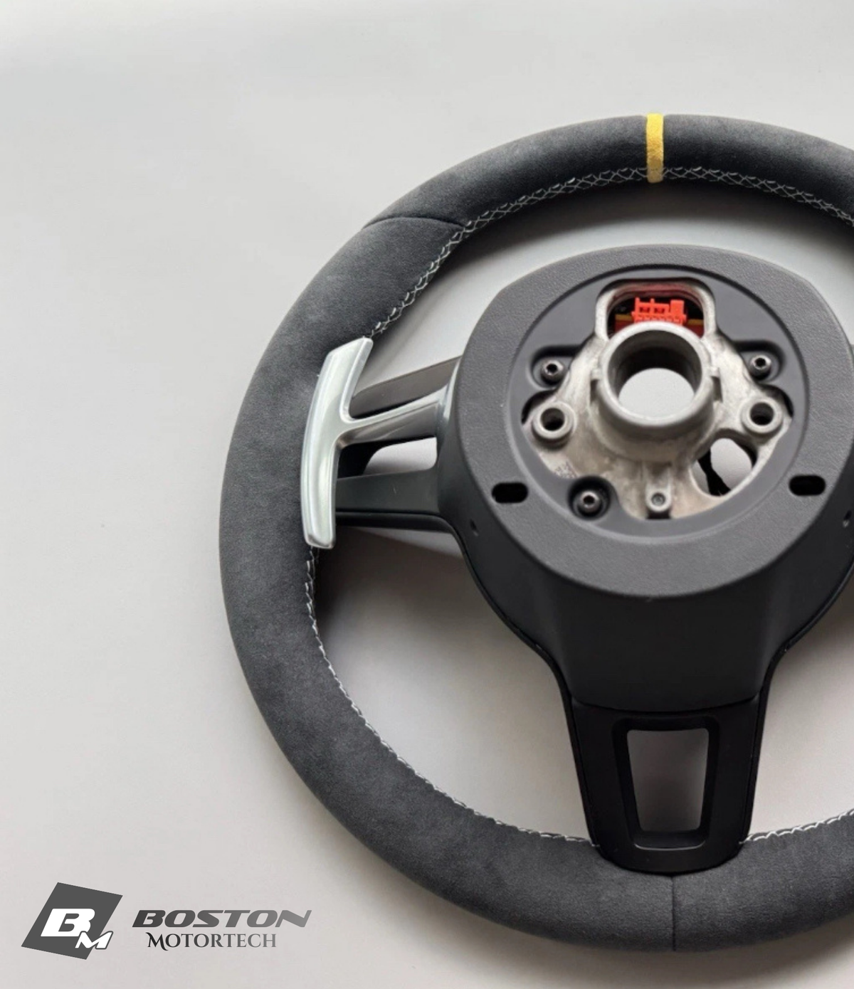 Yellow PDK Porsche 991.2 steering wheel by Boston Motortech with black accents and sporty design.