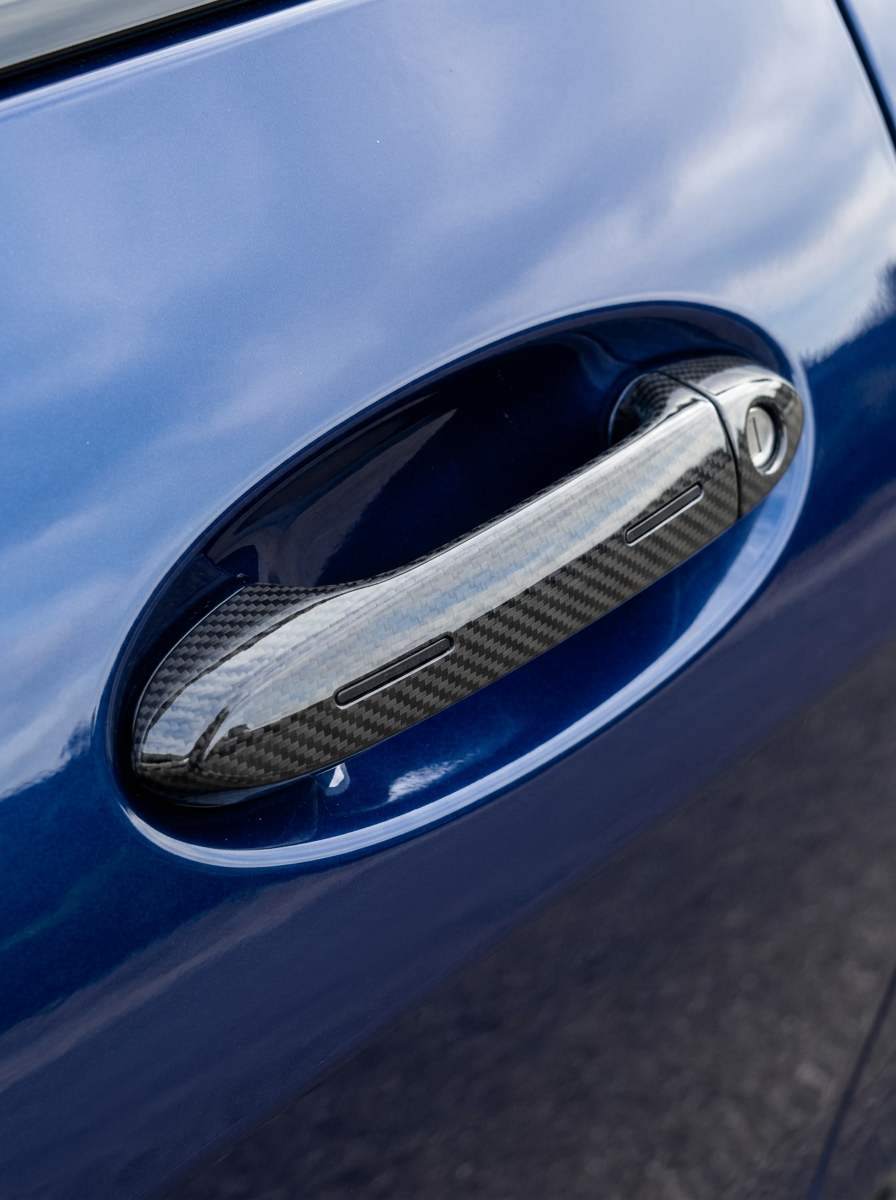 BMW 4 Series G82 M4 Carbon Fiber Door Handle Cover by K2 Industries, showing sleek black carbon fiber finish on car door handle.