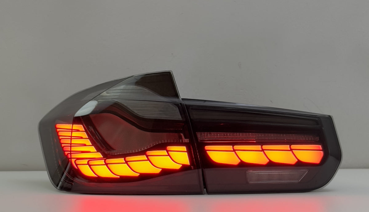 Vekto GTS Dragon Scale LED tail lights installed on a BMW F30/F35/F80 2012-2019 showing vibrant red and clear lighting elements