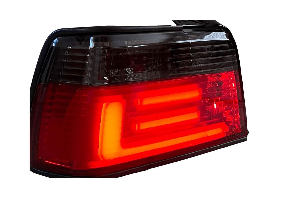 BMW 3 Series E36 sedan JDM red and smoke LED bar tail lights by K2 Industries, showing close-up of rear lighting design.