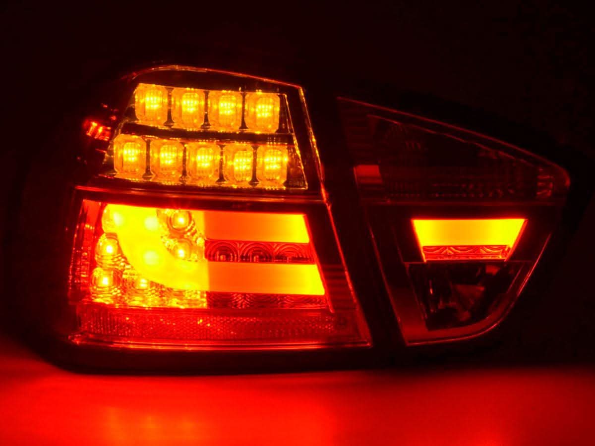 BMW 3-Series E90 sedan tail lights with red and clear LED bars, aftermarket tail lights by K2 Industries for 2005-2008 models.