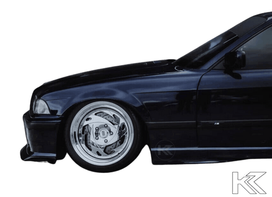 BMW E36 M3 Series 3 JDM Style front lip in black from K2 Industries, designed for 1992-1999 models, shown on the car's front bumper.