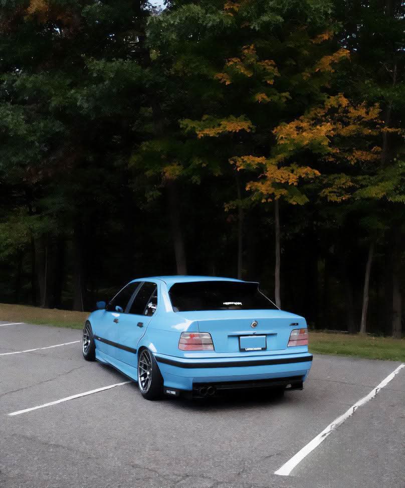 Black BMW E36 Sedan Series 3 HM Style Roof Spoiler by K2 Industries, mounted on the roof of the vehicle.