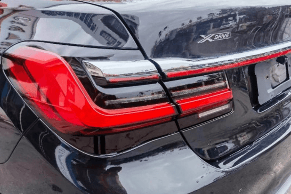 BMW F02 7 Series red LED tail lights by K2 Industries, luxury beam style, for models from 2008 to 2015, showing installed tail light assembly.