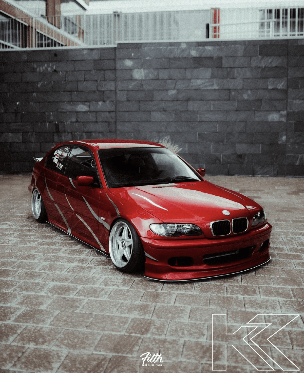 BMW E46 Sedan/Touring front lip in JDM style V1 by K2 Industries, showcasing the aerodynamic design and fitment for 1999-2006 models.