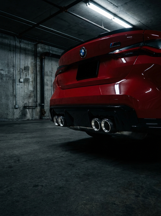 Set of four carbon fiber exhaust tips for BMW M series, 60-80mm inlet, featuring sleek finish and sporty design by K2 Industries.
