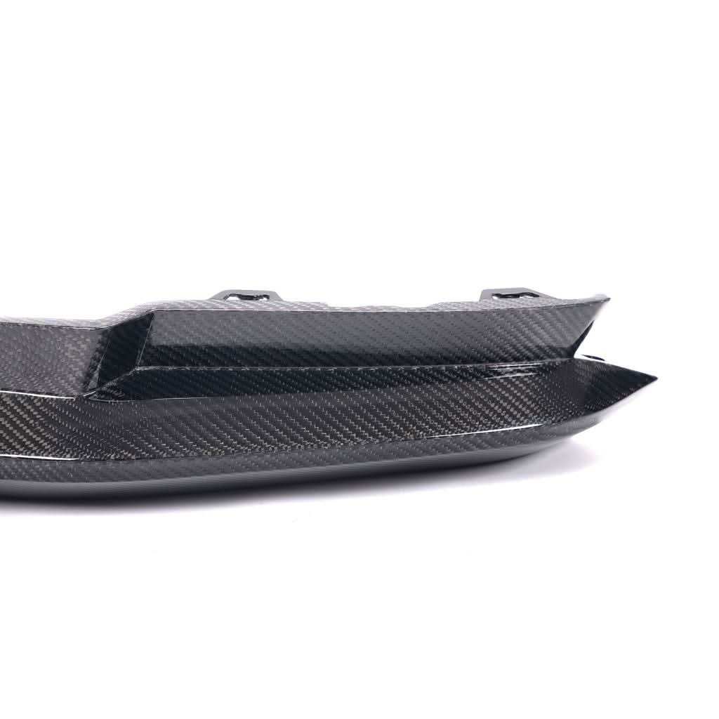Pair of dry carbon fiber front splitter winglets for BMW G80 M3 and G82 M4 Competition by K2 Industries, installed on vehicle front.