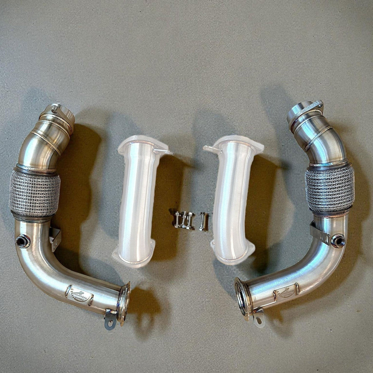 Palenon Performance S68 racing downpipes for BMW G90 G99 M5, stainless steel exhaust components with precision welds and flanges.