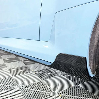 BMW 2 Series G87 M2 carbon fiber A Style side skirts by K2 Industries, showing sleek, aerodynamic design on a 2023 model.