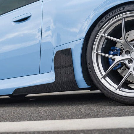 BMW M2 G87 M Type carbon fiber side skirt extensions by Palenon Performance, showing sleek aerodynamic design and textured carbon fiber finish.