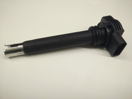 Genuine OEM Audi ignition coil for 3.2L A3, 3.6L Q7, TT engine, showing the black coil with electrical connectors.