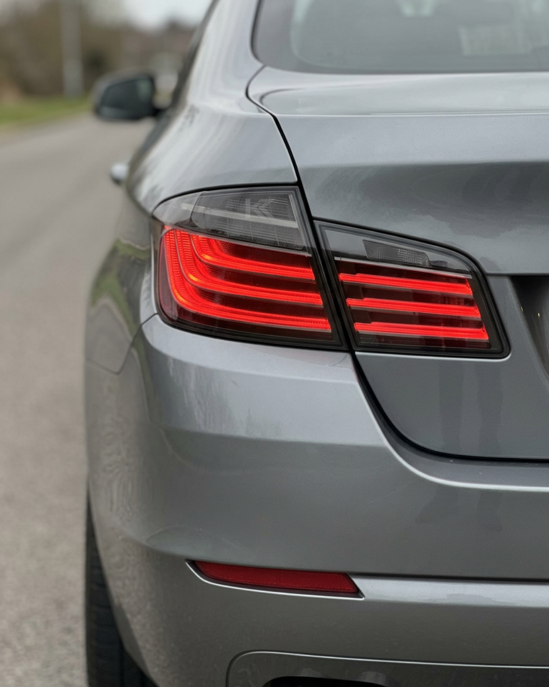 Black BMW 5 Series F10 LED tail lights by K2 Industries, showcasing sleek black and clear lens design for 2011–2017 models