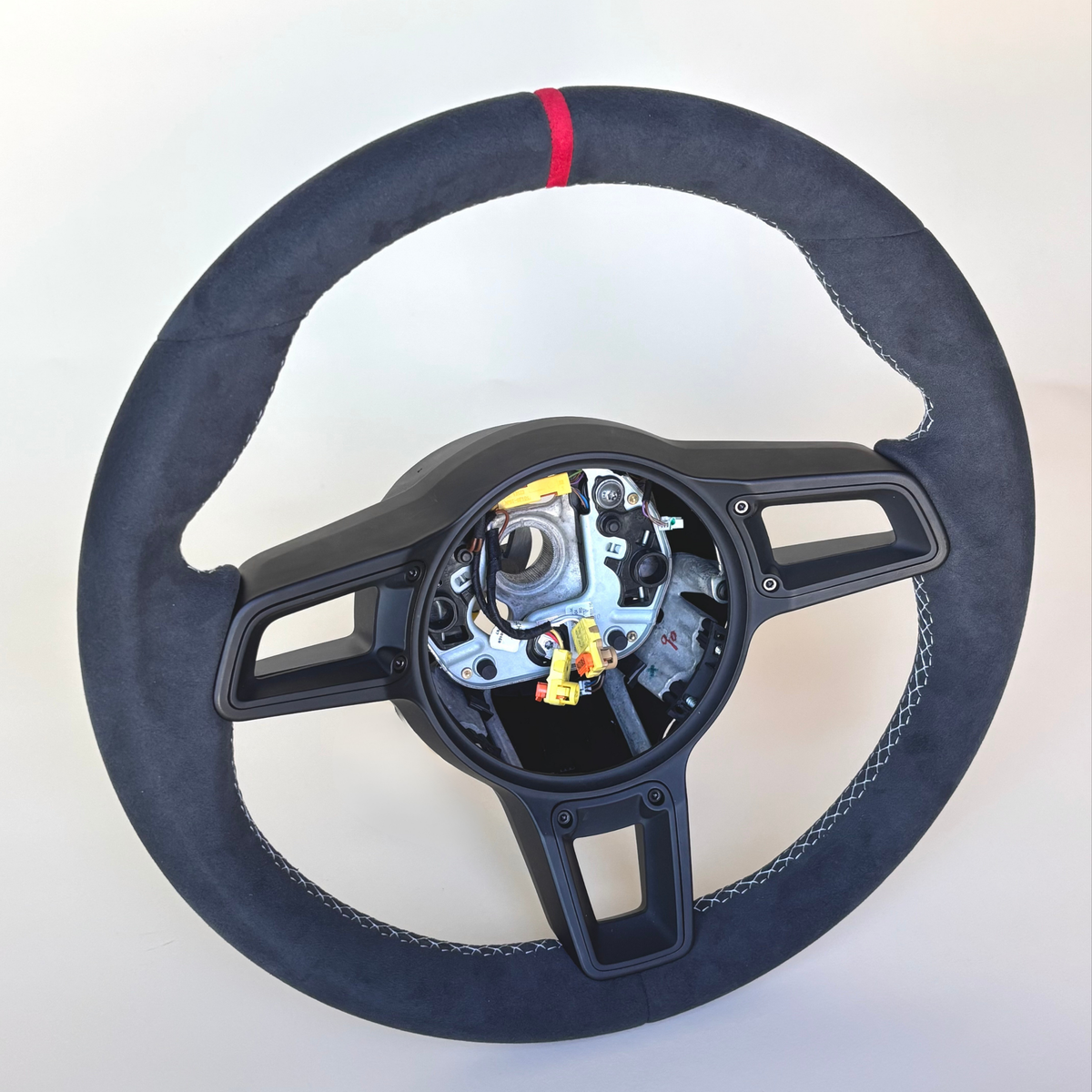 Red manual Porsche 991.2 steering wheel interior trim by Boston Motortech, showing detailed red leather and control accents.