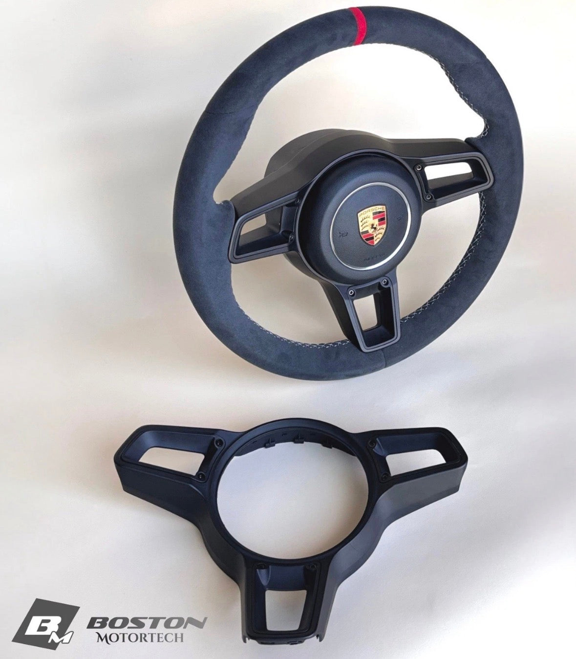 Red manual steering wheel for Porsche 991.2 by Boston Motortech, featuring a sporty design and premium craftsmanship.