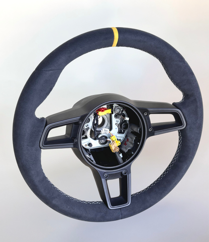 Yellow manual Porsche 991.2 steering wheel by Boston Motortech with detailed grip and button accents for sports car interior.