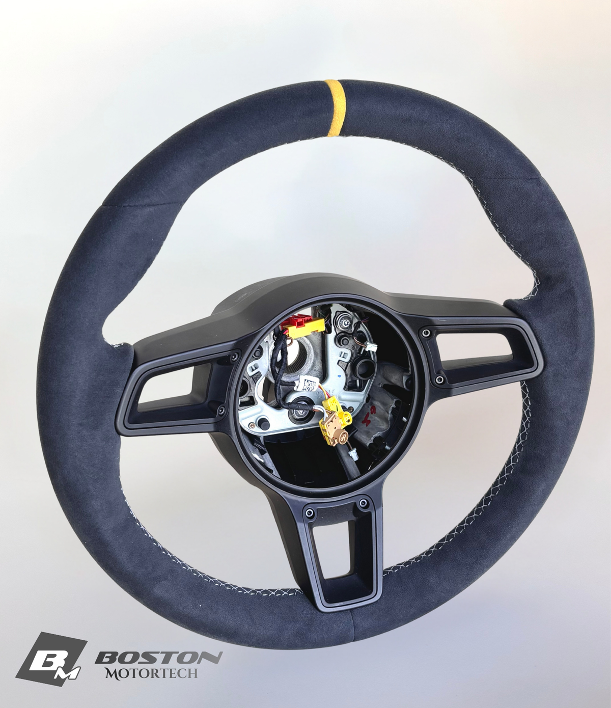 Yellow manual Porsche 991.2 steering wheel by Boston Motortech, featuring detailed grip and control buttons.