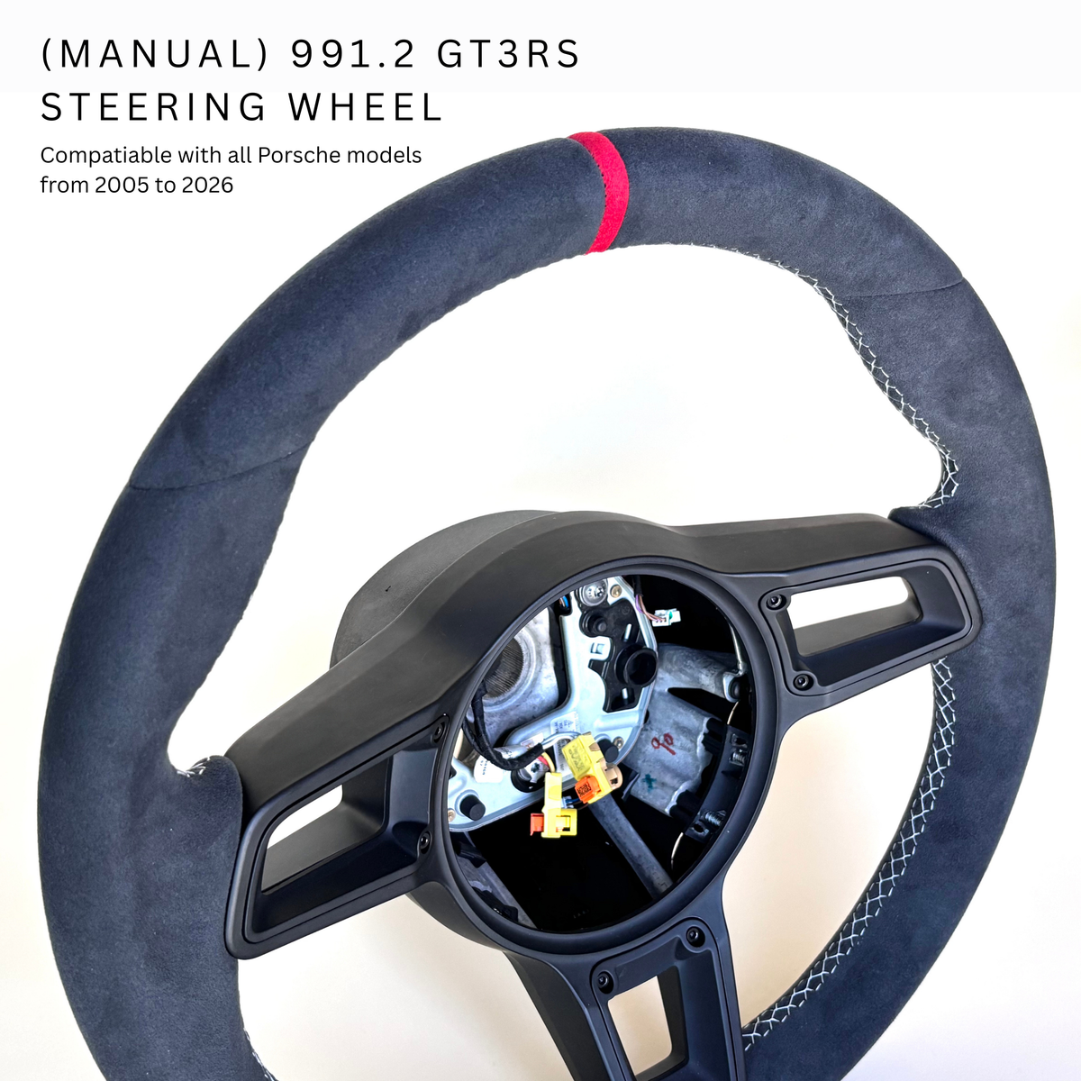 Red manual Porsche 991.2 steering wheel by Boston Motortech, featuring sporty leather grips and detailed stitching.