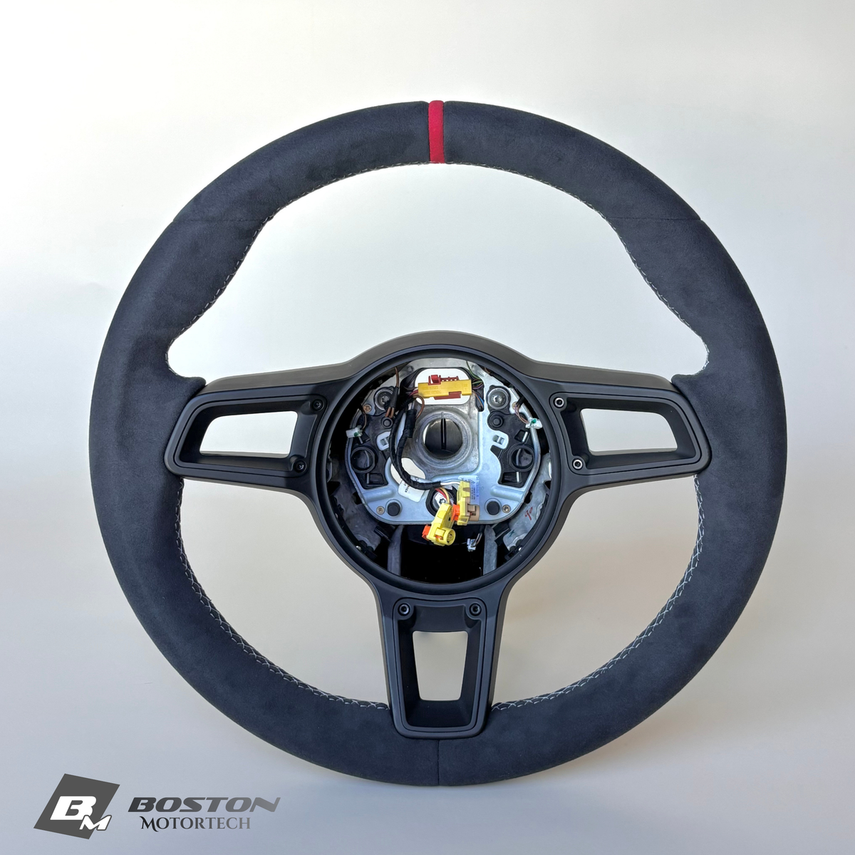 Red manual Porsche 991.2 steering wheel interior trim by Boston Motortech with detailed stitching and ergonomic design.