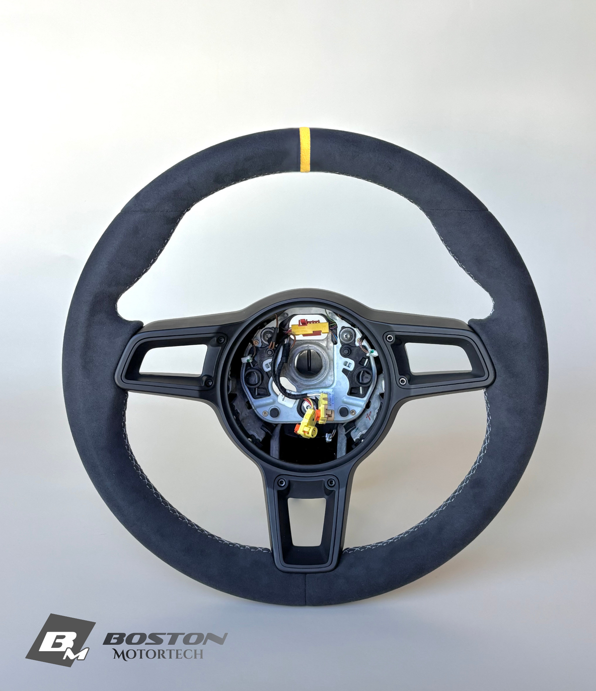 Yellow manual Porsche 991.2 steering wheel by Boston Motortech, showing leather wrapping and detailed grip design
