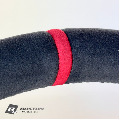Red manual Porsche 991.2 steering wheel interior trim by Boston Motortech, showcasing a sleek, sporty design with detailed stitching.