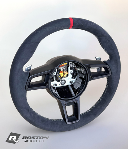 Red Porsche 991.2 steering wheel by Boston Motortech, featuring a sporty design with control buttons and a sleek finish.