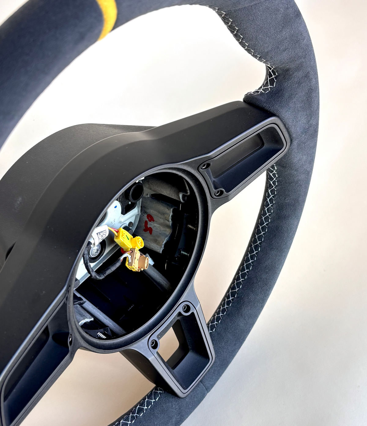 Yellow manual Porsche 991.2 steering wheel by Boston Motortech with black accents and ergonomic grip design.
