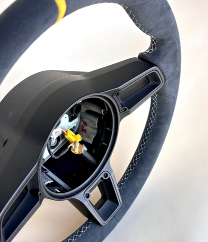 Yellow manual Porsche 991.2 steering wheel by Boston Motortech with black accents and ergonomic grip design.