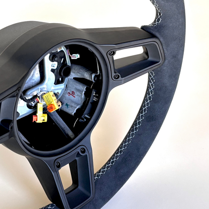 Red manual Porsche 991.2 steering wheel by Boston Motortech, featuring leather grip and sporty design.