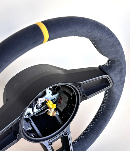 Yellow manual Porsche 991.2 steering wheel by Boston Motortech, featuring a sleek design with detailed grips and branding.