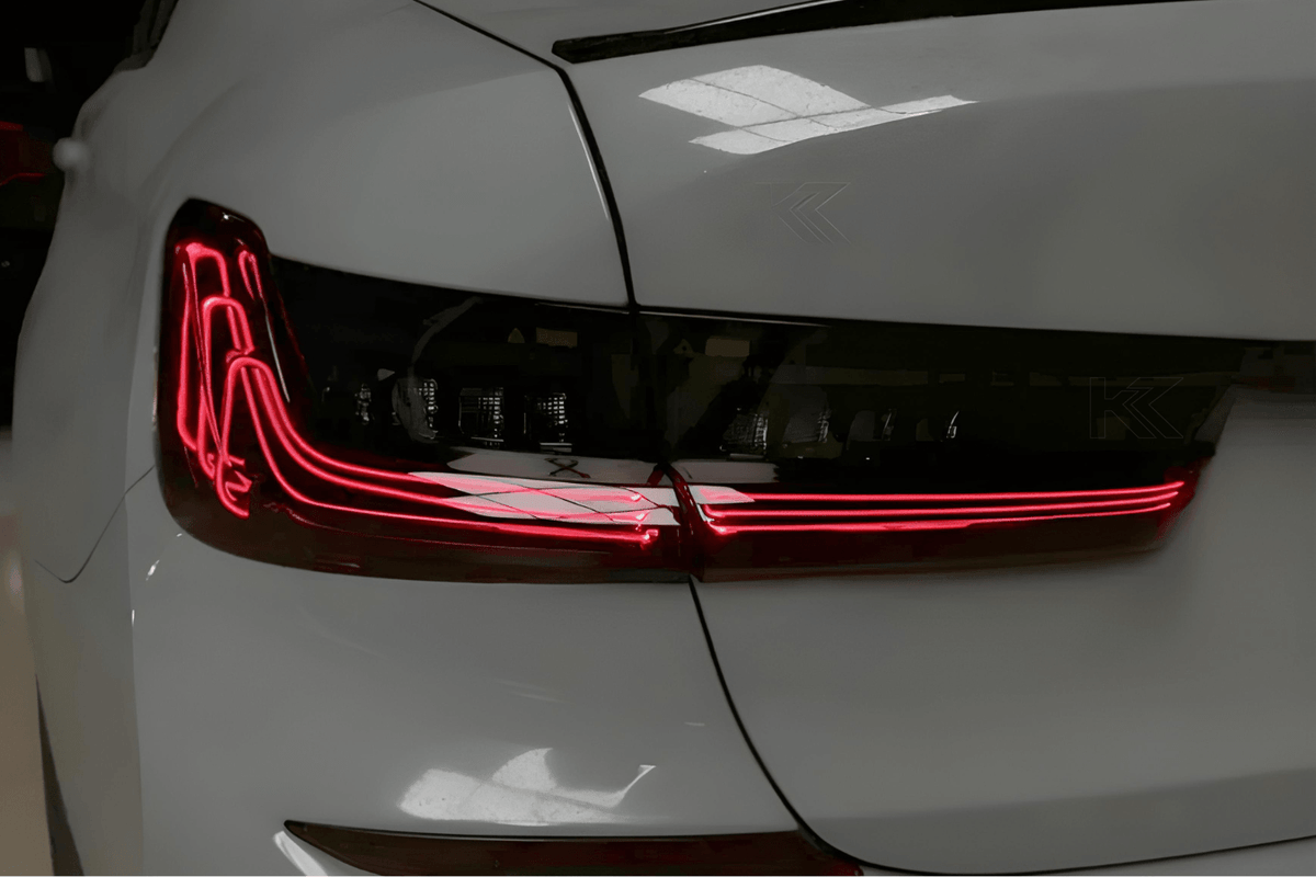 BMW 3 Series G20 G28 tail lights in red and smoked CSL style with laser accents by K2 Industries, shown on a 2019-2024 model.
