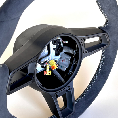 Red manual Porsche 991.2 steering wheel interior trim by Boston Motortech, showing detailed leather and mounting points.