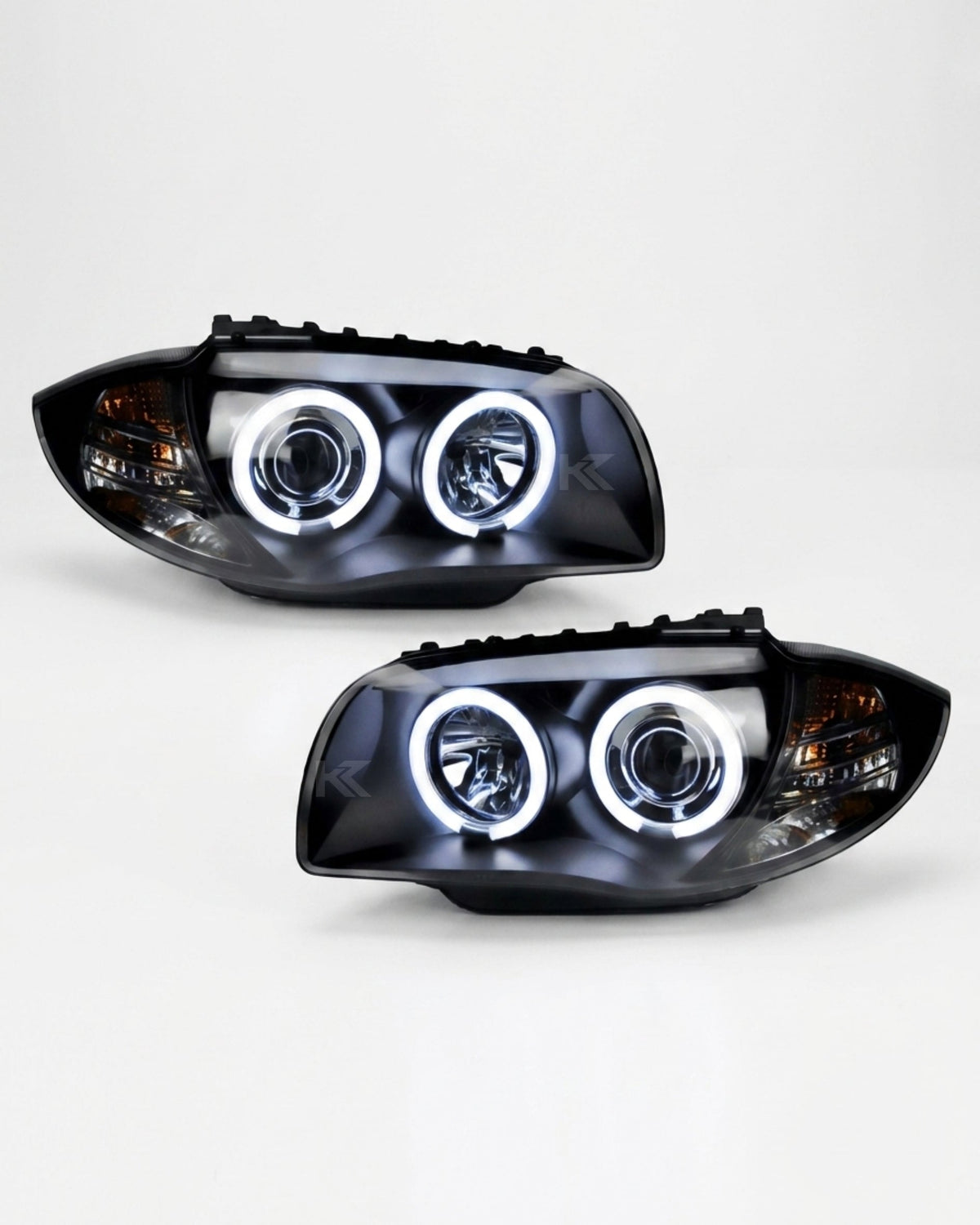 BMW 1 Series 120i 118i E87 headlights with angel eyes LED lights, branded by K2 Industries, showing the front view of the headlights.