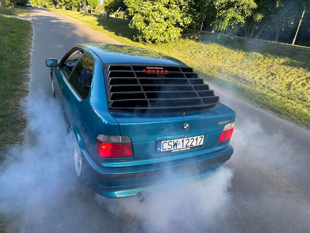 BMW E36 Compact Series 3 black windshield louvers by K2 Industries, showing the sleek vent design on the rear windshield.