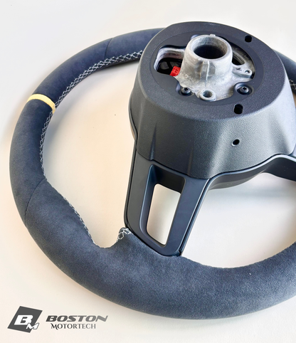 Yellow manual Porsche 991.2 steering wheel by Boston Motortech with black accents and ergonomic grip details.