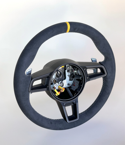 Yellow Porsche 991.2 steering wheel by Boston Motortech, showing the sporty design and textured grip details.