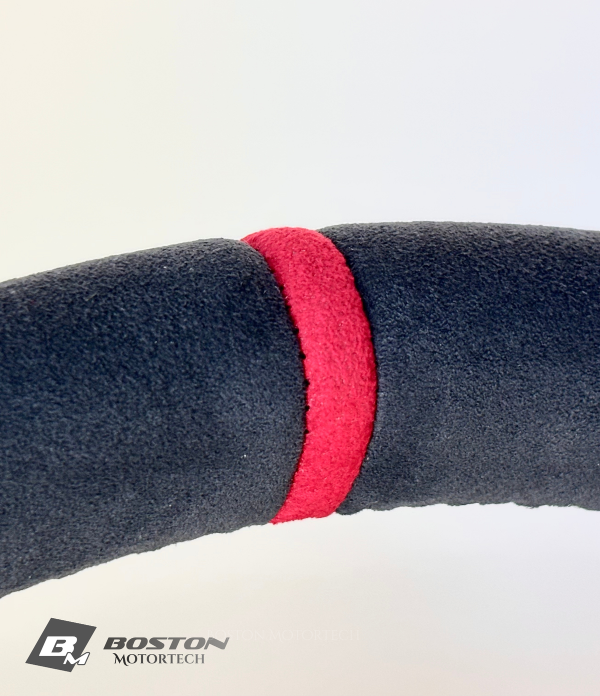 Red PDK Porsche 991.2 steering wheel by Boston Motortech, featuring leather grip and sporty design.