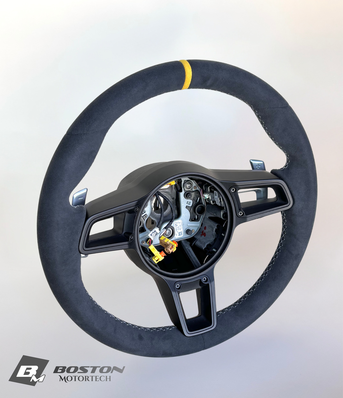 Yellow Porsche 991.2 steering wheel by Boston Motortech with black grip accents, detailed view of the sporty interior accessory.