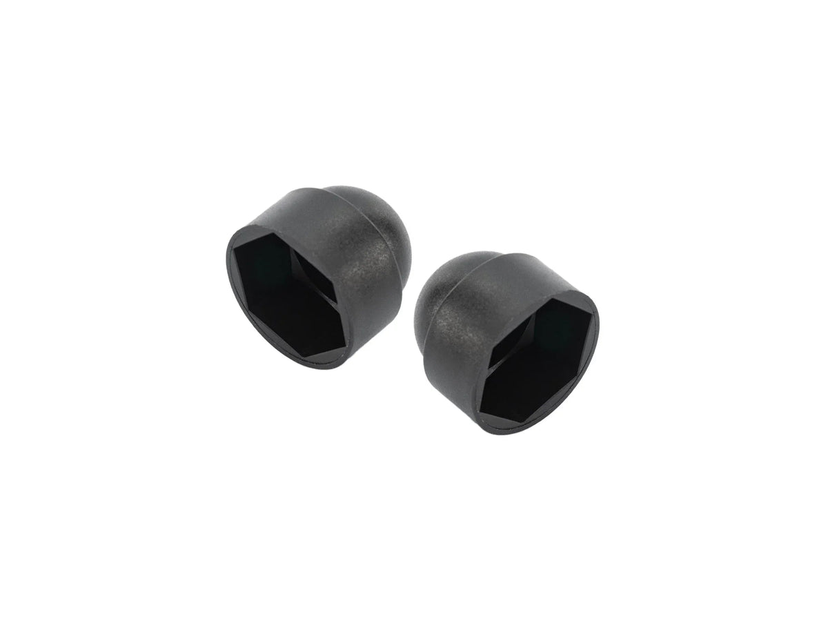 Pair of GoWesty pivot bolt caps for Vanagon rear suspension, showcasing black rubber caps installed on suspension components.