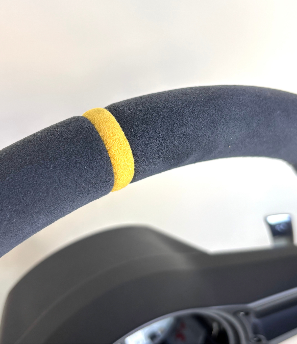 Yellow PDK Porsche 991.2 steering wheel by Boston Motortech with textured grip and control buttons, shown from a front angle.