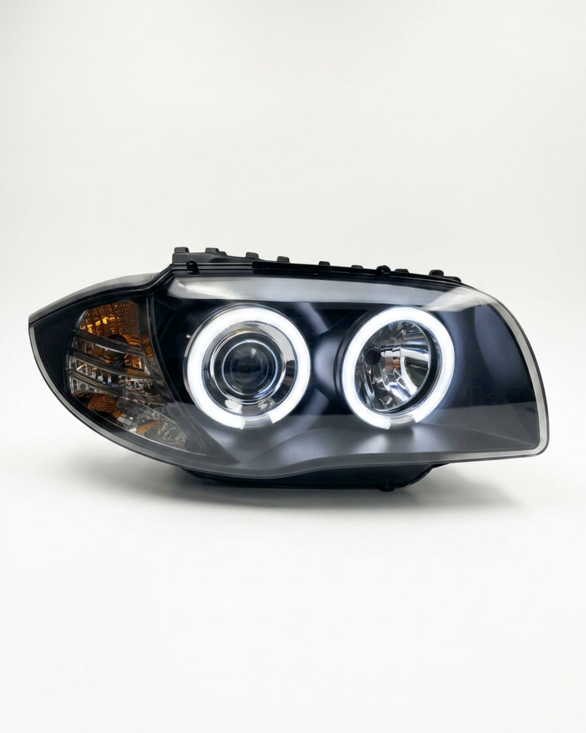 BMW 1 Series 120i 118i E87 headlights with LED angel eyes from K2 Industries, showing the front view of the headlights.