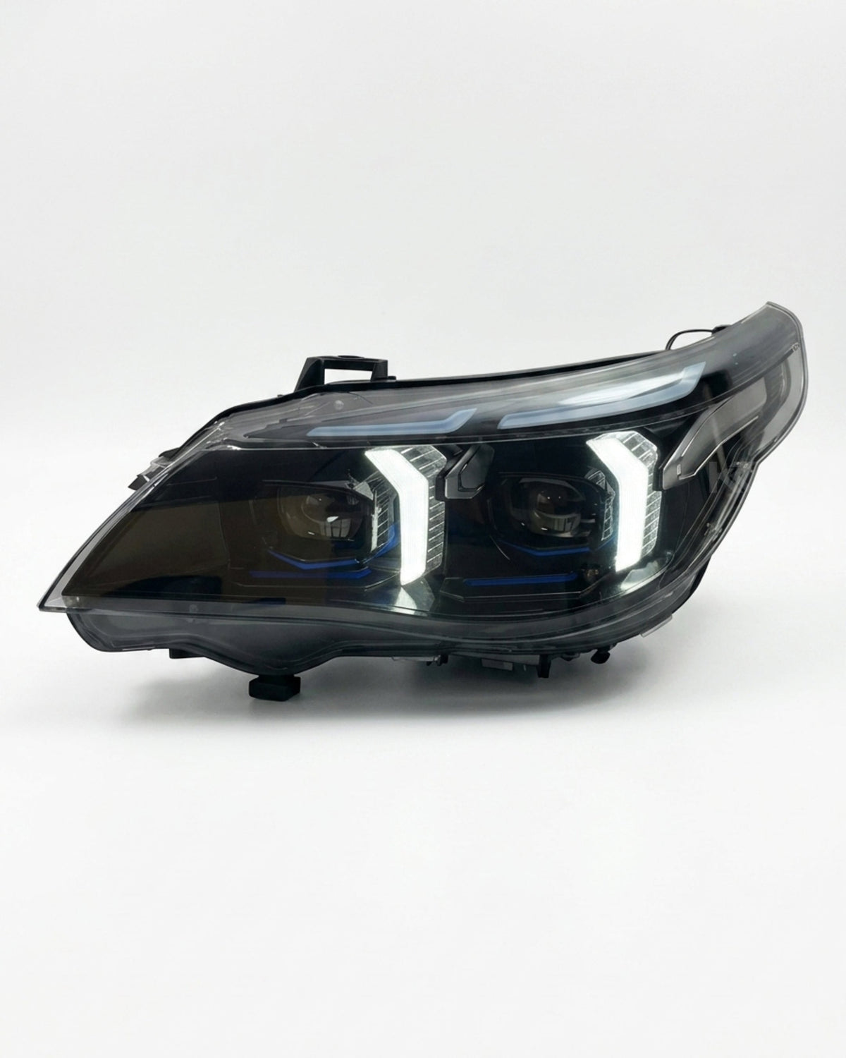 BMW 5 Series E60 Snake Eye LED headlight assembly with dual-color daytime running lights, featuring clear lens and modern design.