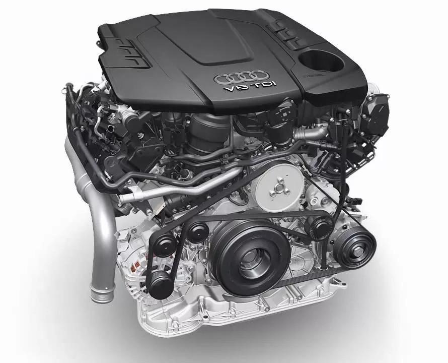 Audi V6 TDI engine with a black plastic engine cover, silver metallic components, and black belts, shown on a light gray background.