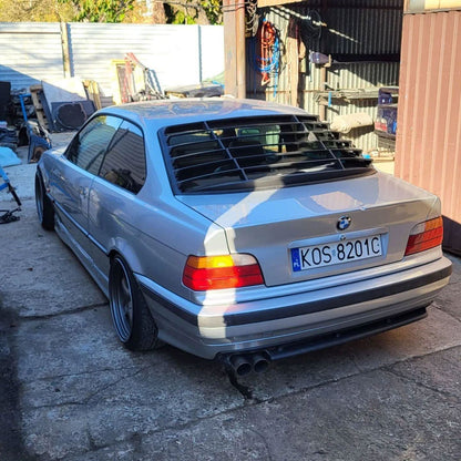 BMW E36 Coupe Series 3 black windshield louvers by K2 Industries, showing the louver design on the rear windshield of the car.