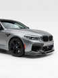 BMW 5 Series F90 M5 3D Style carbon fiber front lip by K2 Industries, showing the sleek, textured carbon fiber design on the car's front bumper.