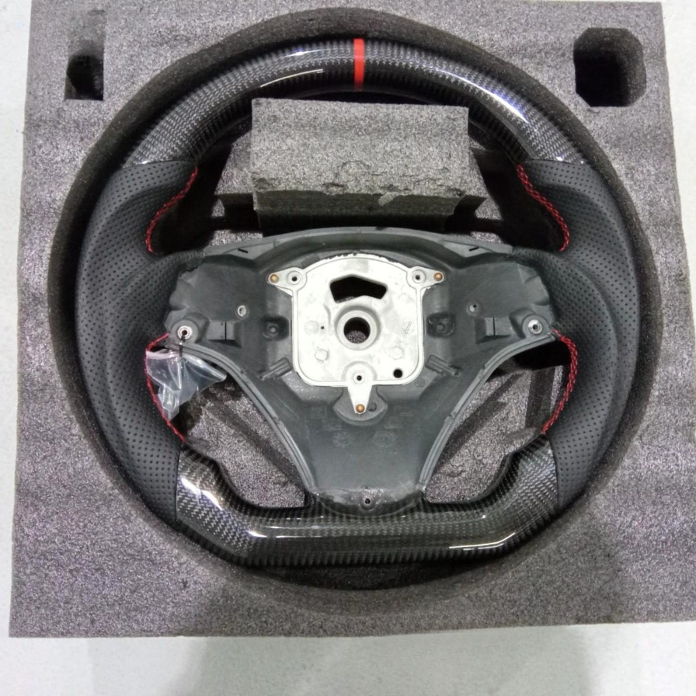 Vekto carbon fiber BMW E90 E92 E93 manual steering wheel with sporty design and textured grip for enhanced driving control.