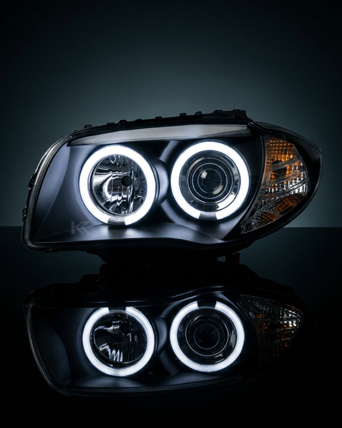 BMW 1 Series E87 headlights with Angel Eyes LED bulbs from K2 Industries, showcasing the front view with illuminated rings.