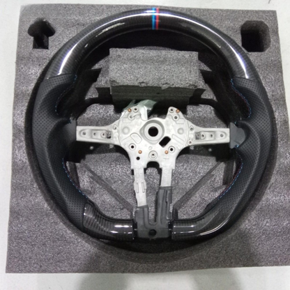 Vekto carbon fiber steering wheel for BMW F30 F-Series with sporty design and textured grip, shown from a side angle.