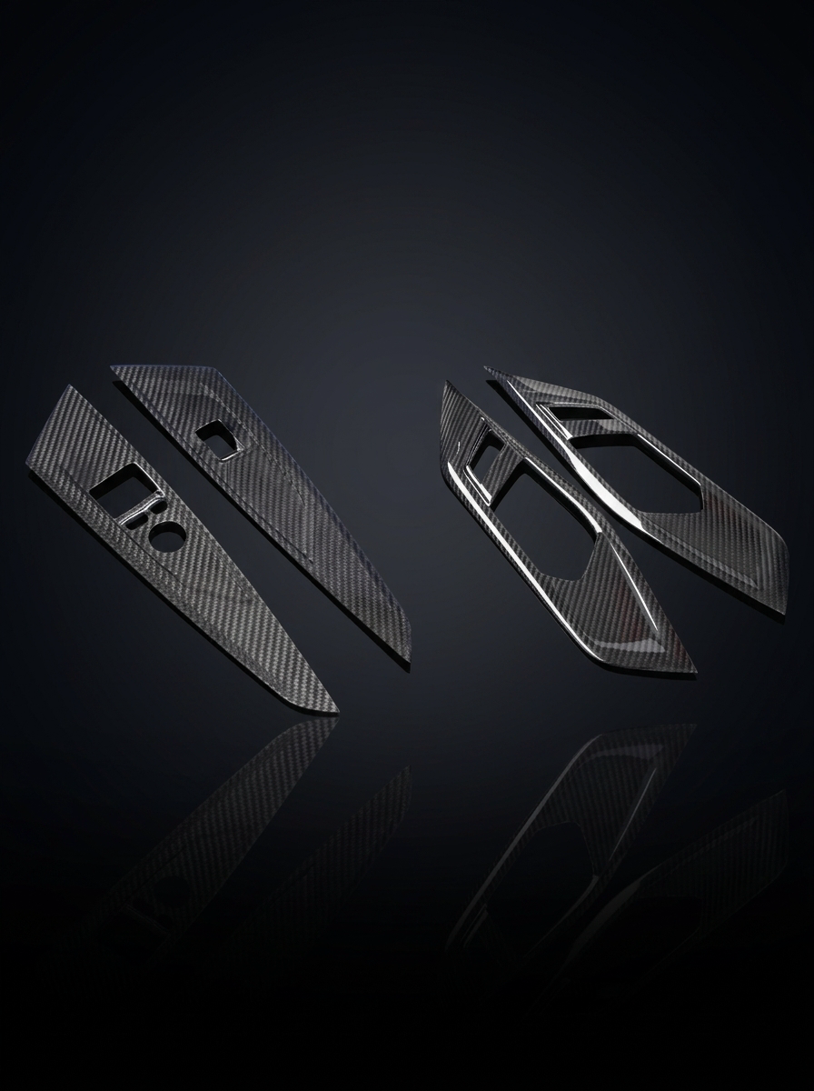 BMW 4 Series G82 G22 carbon fiber interior door trim set by K2 Industries, featuring sleek, textured carbon fiber panels.
