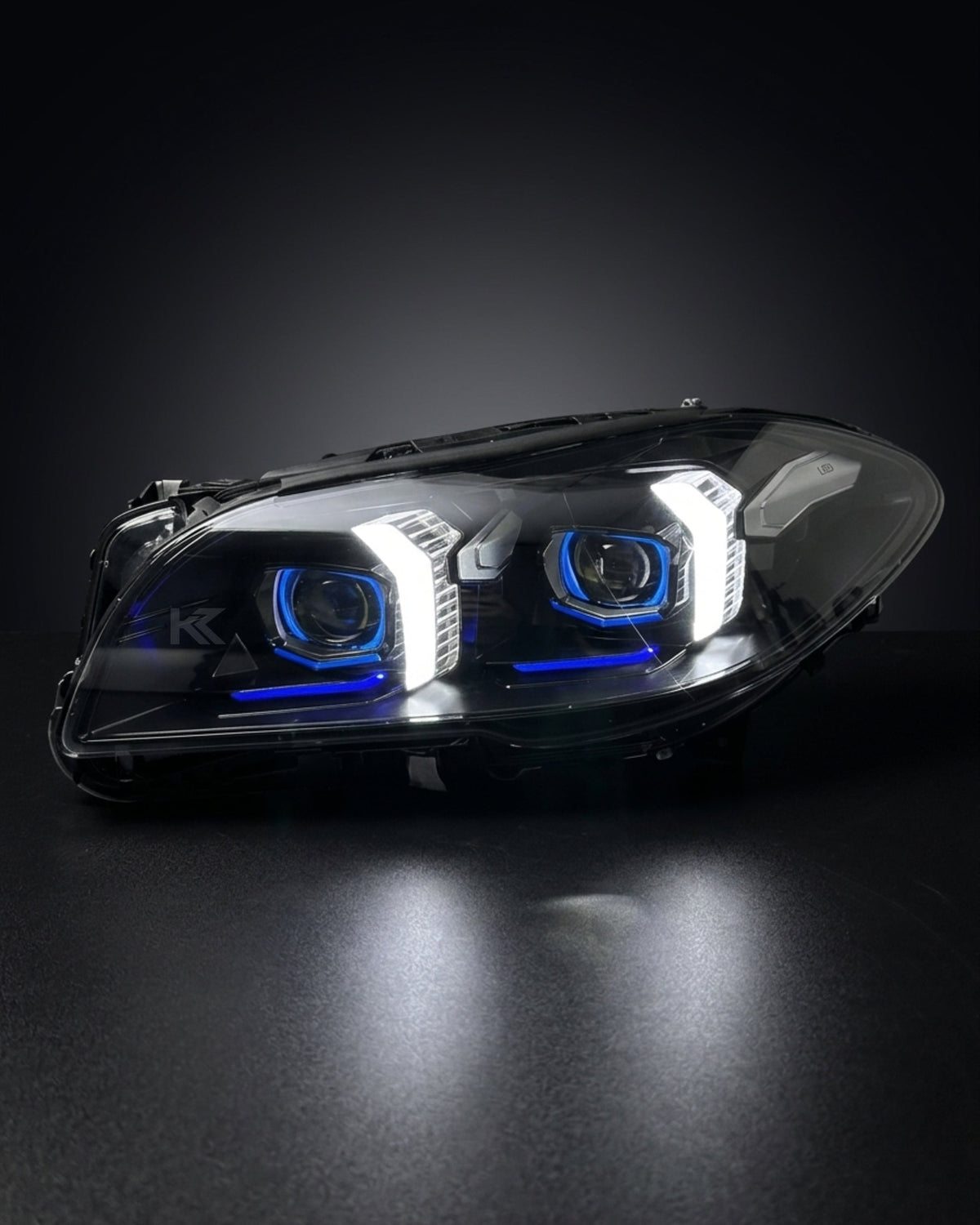 K2 Industries BMW 5 Series F10/F18 LED headlight assembly with high and low beams, 2011-2017, showing the illuminated light units