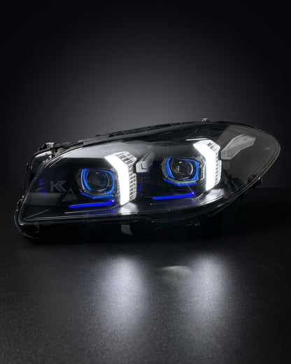 K2 Industries BMW 5 Series F10/F18 LED headlight assembly with high and low beams, 2011-2017, showing the illuminated light units